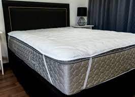 Strapped mattress protector